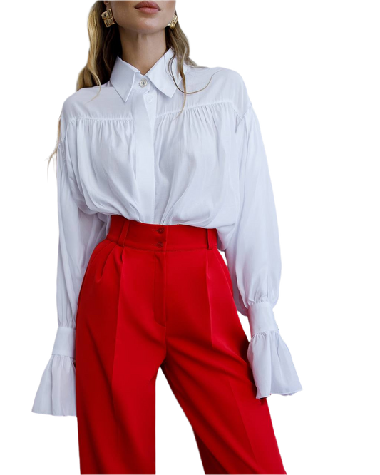 White blouse with ruffled sleeves and red pants on a white background