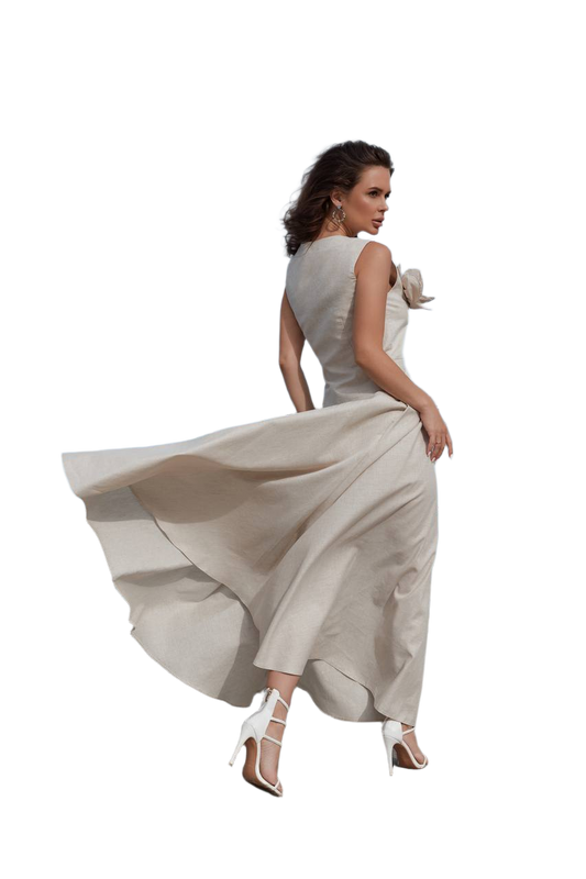 Woman in a flowing beige dress on a white background