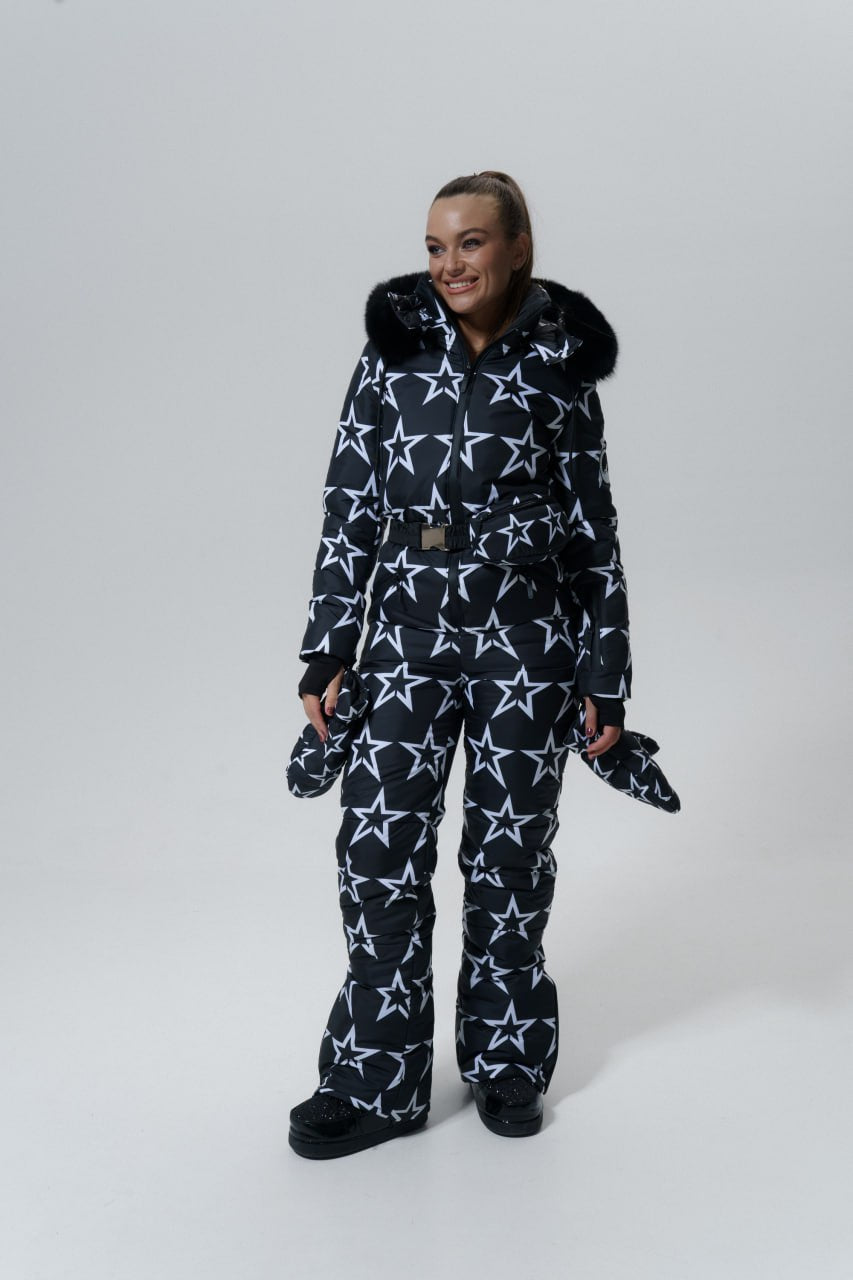 Person wearing a star-patterned snowsuit on a white background