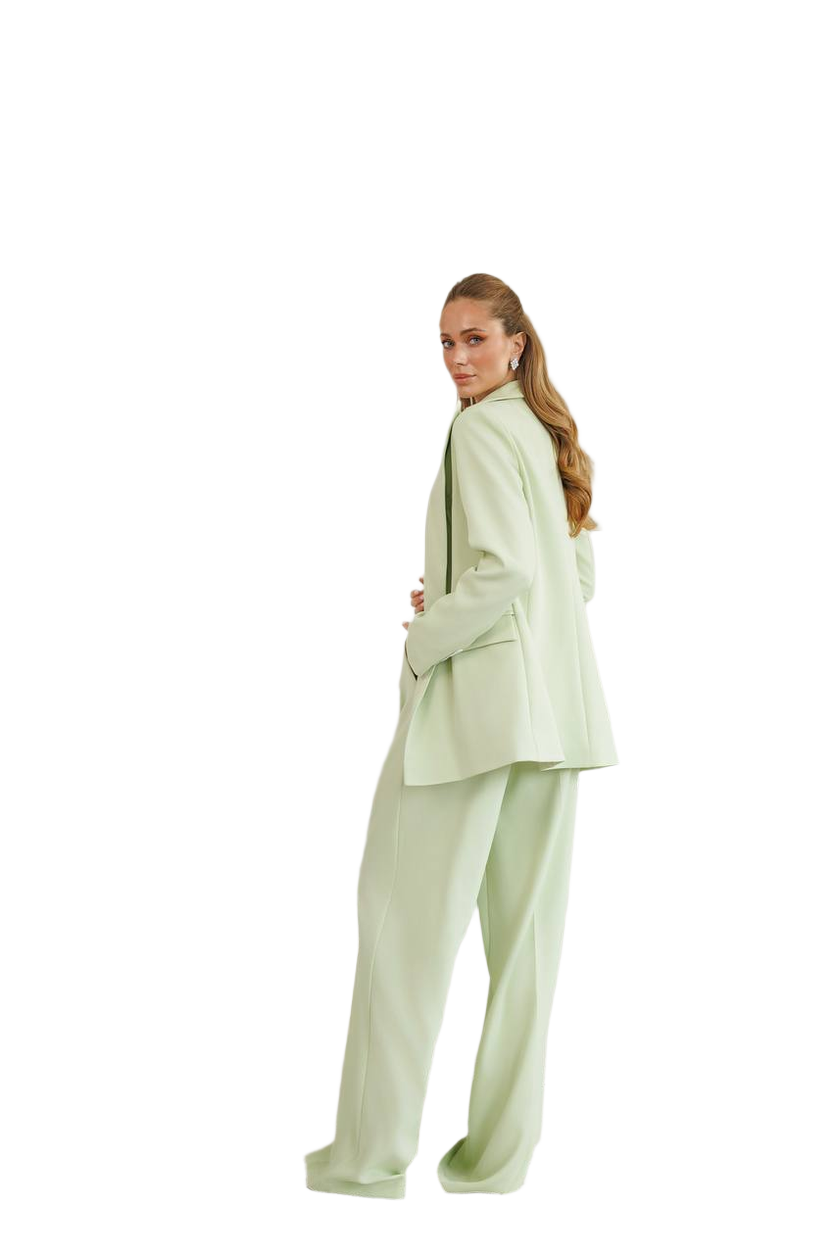 Woman wearing a light green suit on a white background