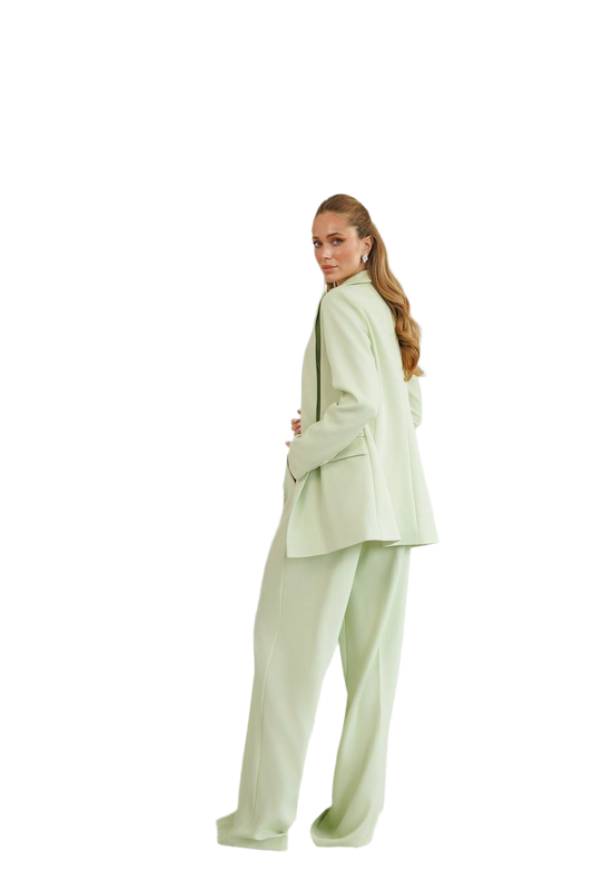 Woman wearing a light green suit on a white background