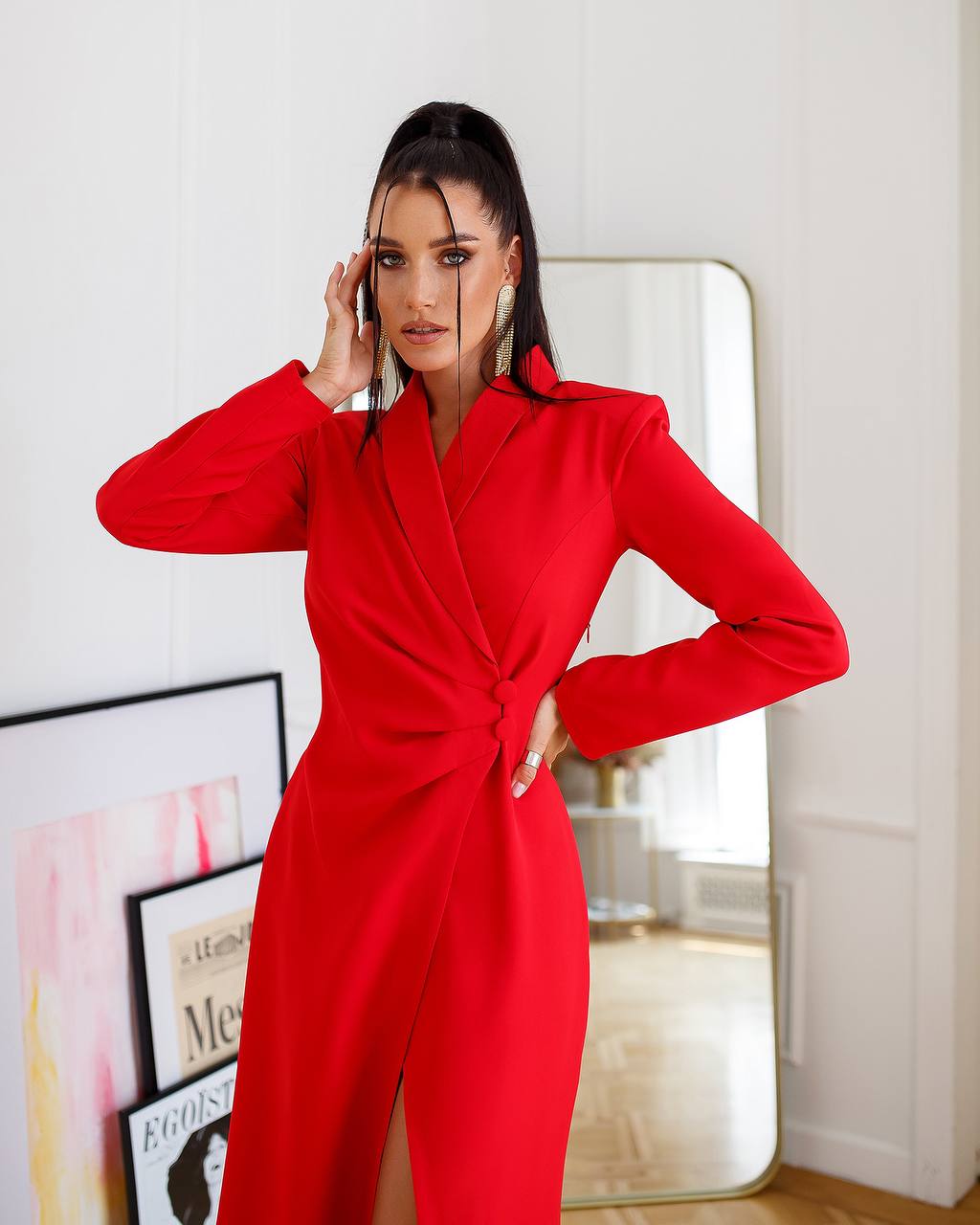 Woman wearing a red jumpsuit in an indoor setting