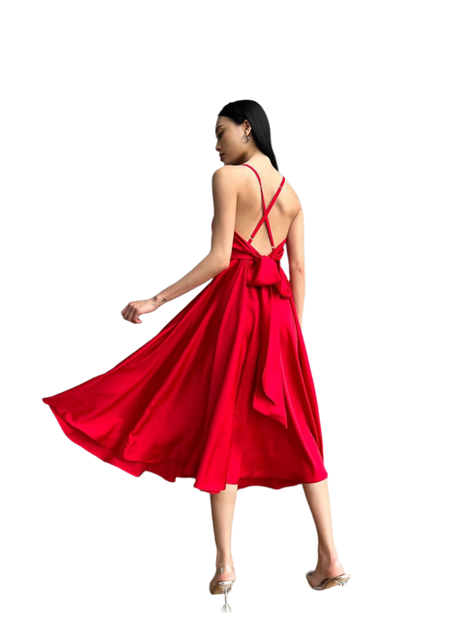 Woman wearing a red dress with thin straps on a white background