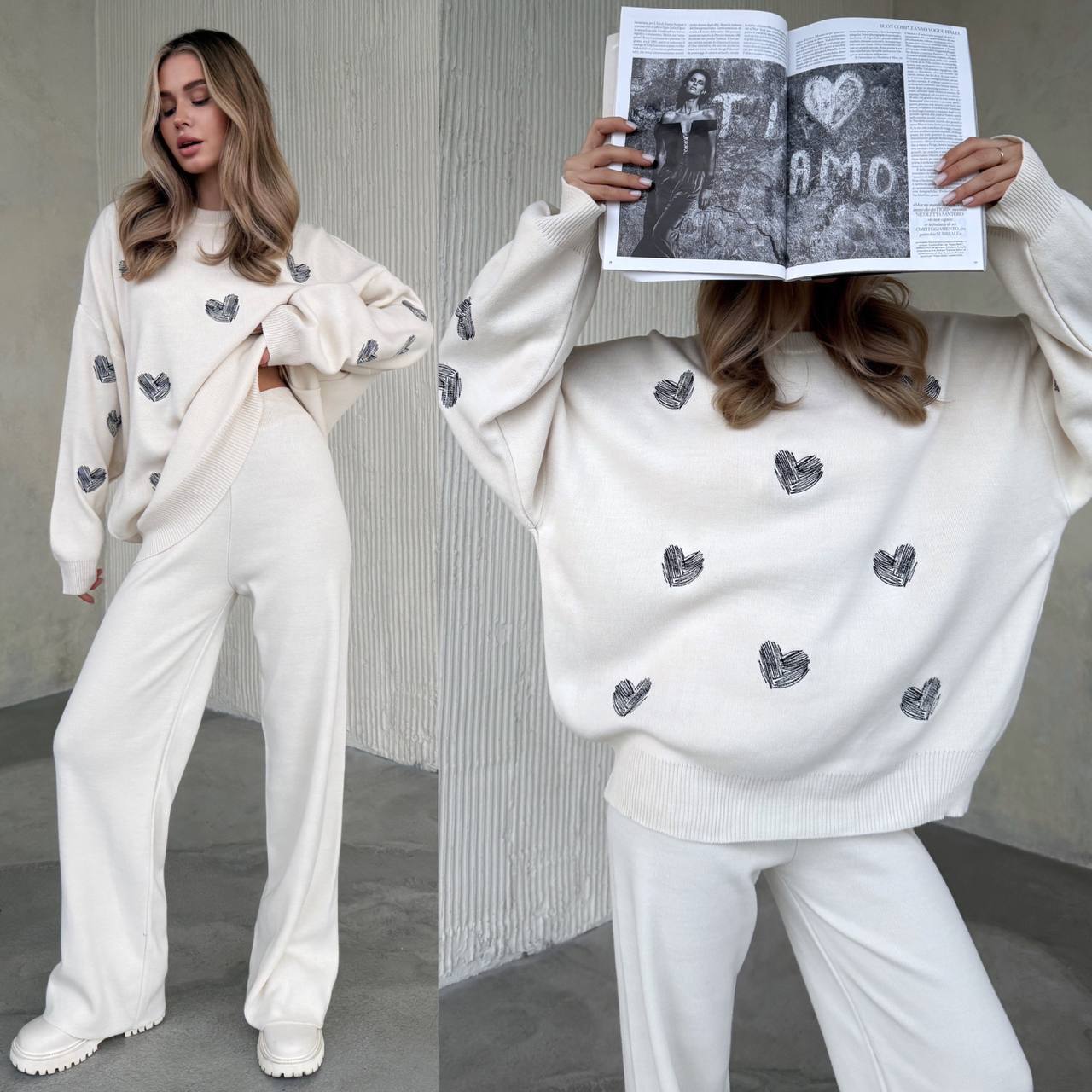 Woman wearing a white outfit with black heart patterns, holding an open book.
