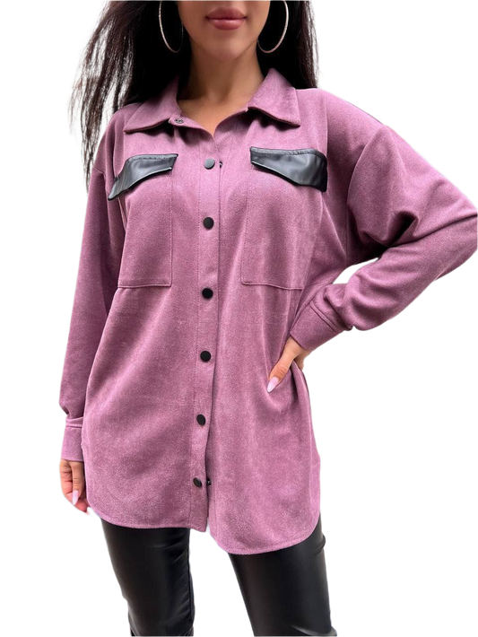 Purple shirt with black leather accents worn by a person on a white background