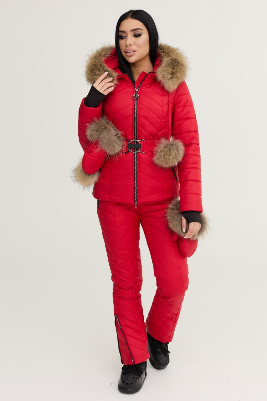 Woman wearing a red puffer suit with fur trim on a white background