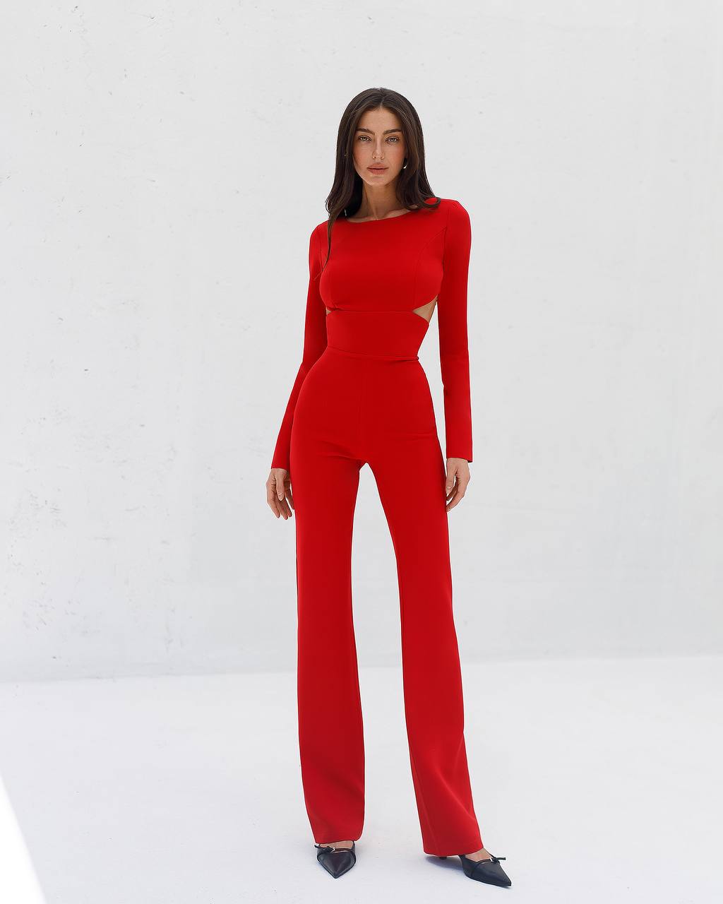 Person wearing a red jumpsuit on a white background