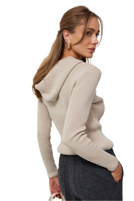 Woman wearing a beige hoodie with a plain background