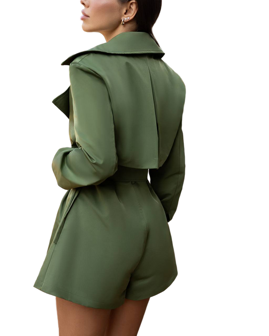 Green trench coat worn by a person on a white background
