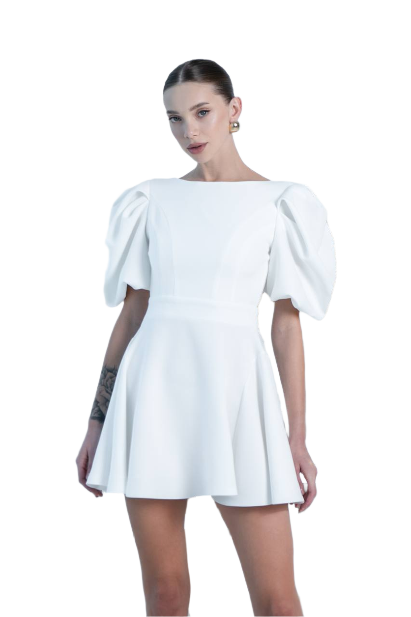 Woman wearing a white dress with puffed sleeves on a white background