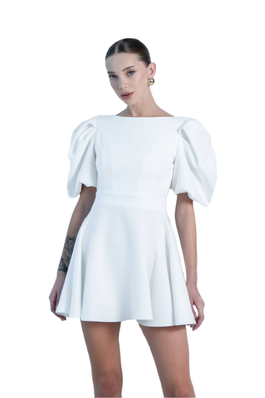 Woman wearing a white dress with puffed sleeves on a white background