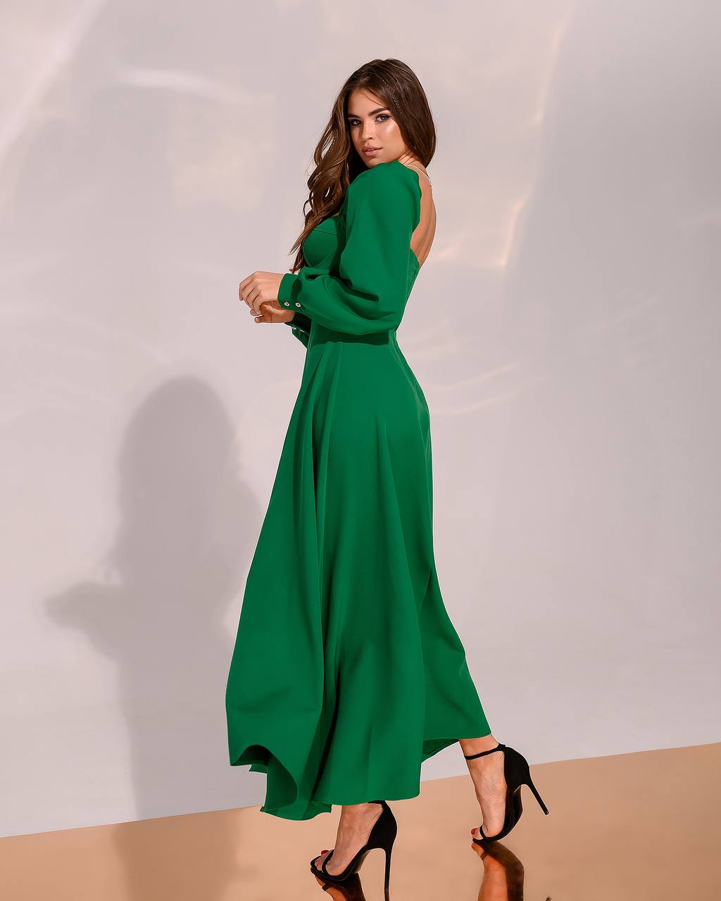 Woman wearing a green dress against a white background