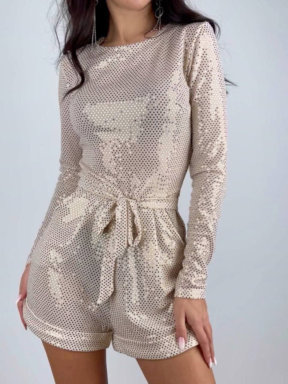 Beige patterned romper worn by a person on a plain background