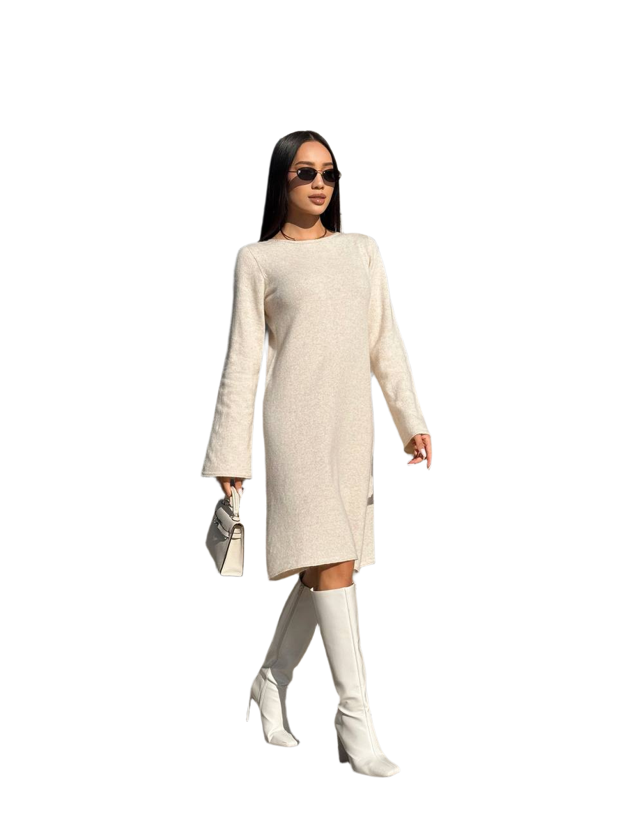 Woman wearing a beige dress and white knee-high boots on a white background