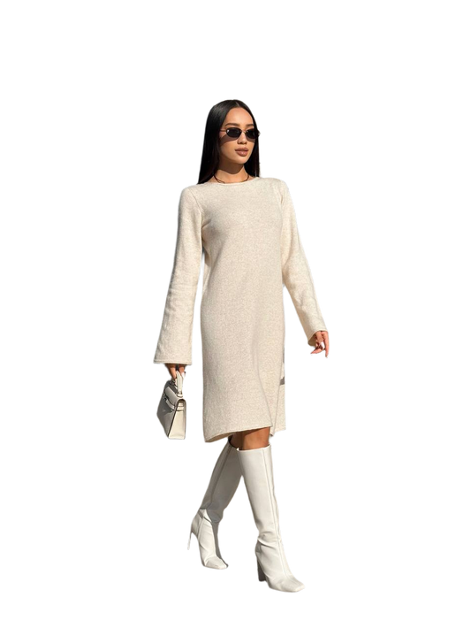Woman wearing a beige dress and white knee-high boots on a white background