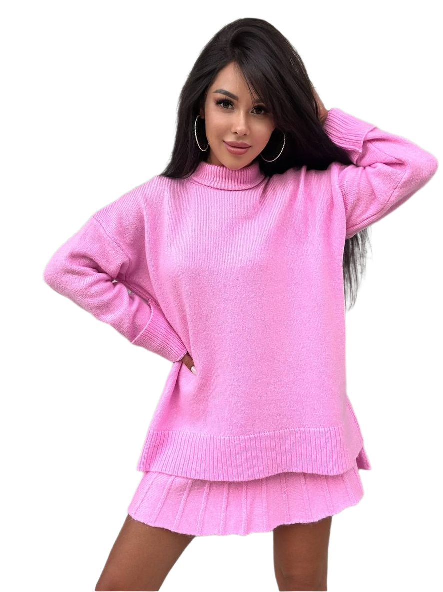 Woman wearing a pink sweater and skirt set on a white background