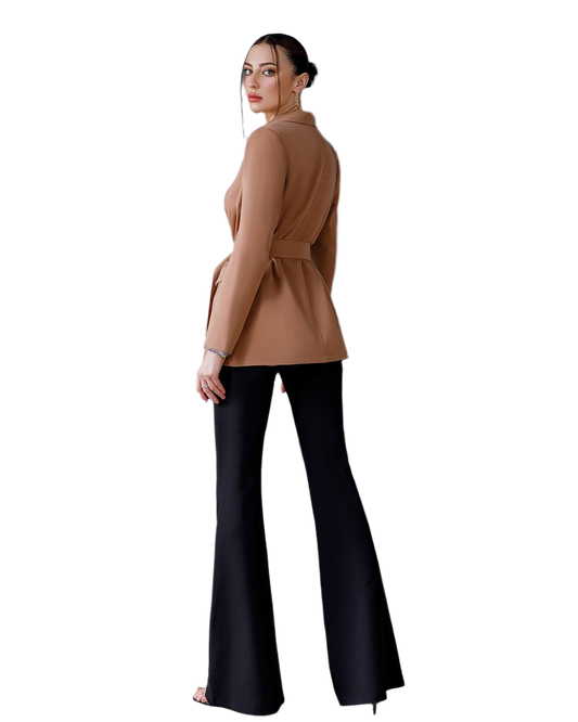 Woman wearing a tan top and black flared pants on a white background
