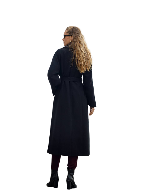 Person wearing a long black coat on a white background
