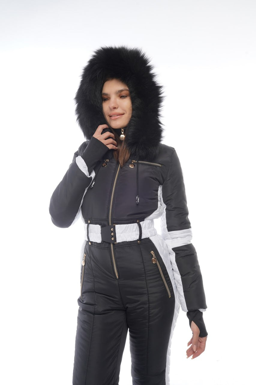 Person wearing a black winter jacket with fur hood on a white background