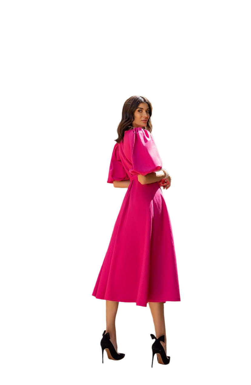 Woman wearing a pink dress with a white background