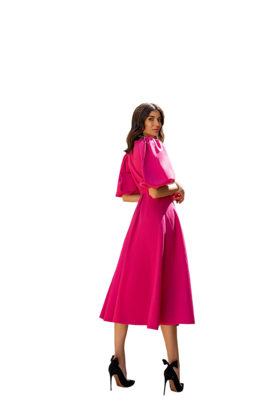 Woman wearing a pink dress with a white background