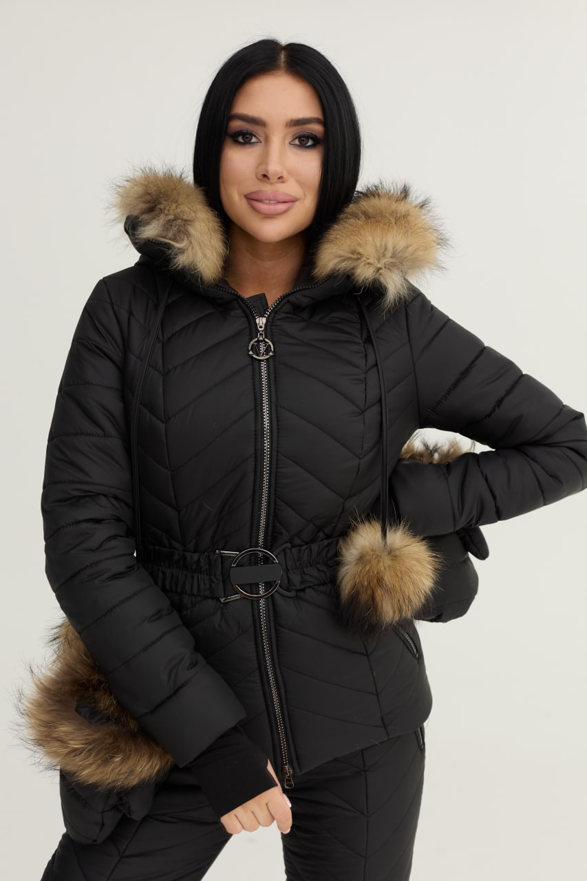 Woman wearing a black puffer jacket with fur trim on a white background