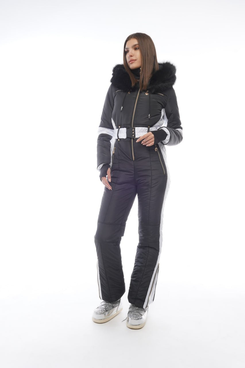 Person wearing a black and gray snowsuit with white accents on a white background