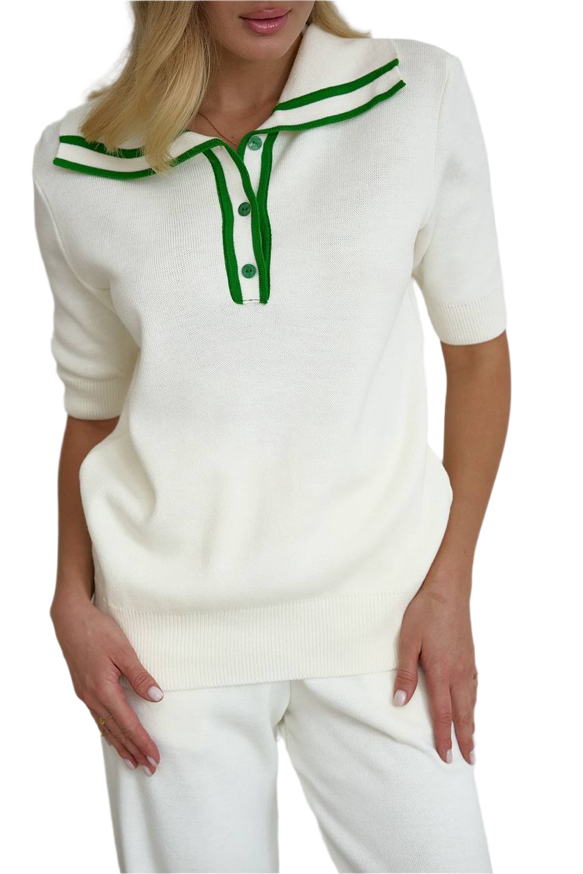 White sweater with green accents worn by a person on a white background