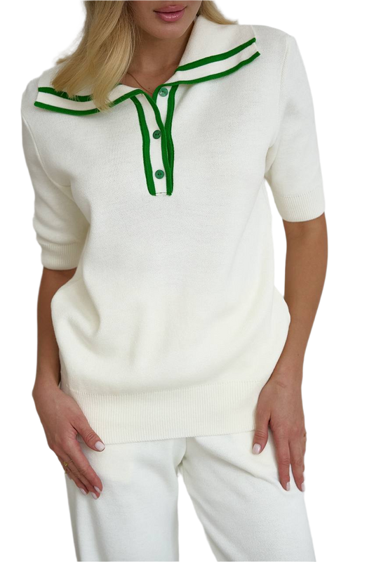 White sweater with green accents worn by a person on a white background