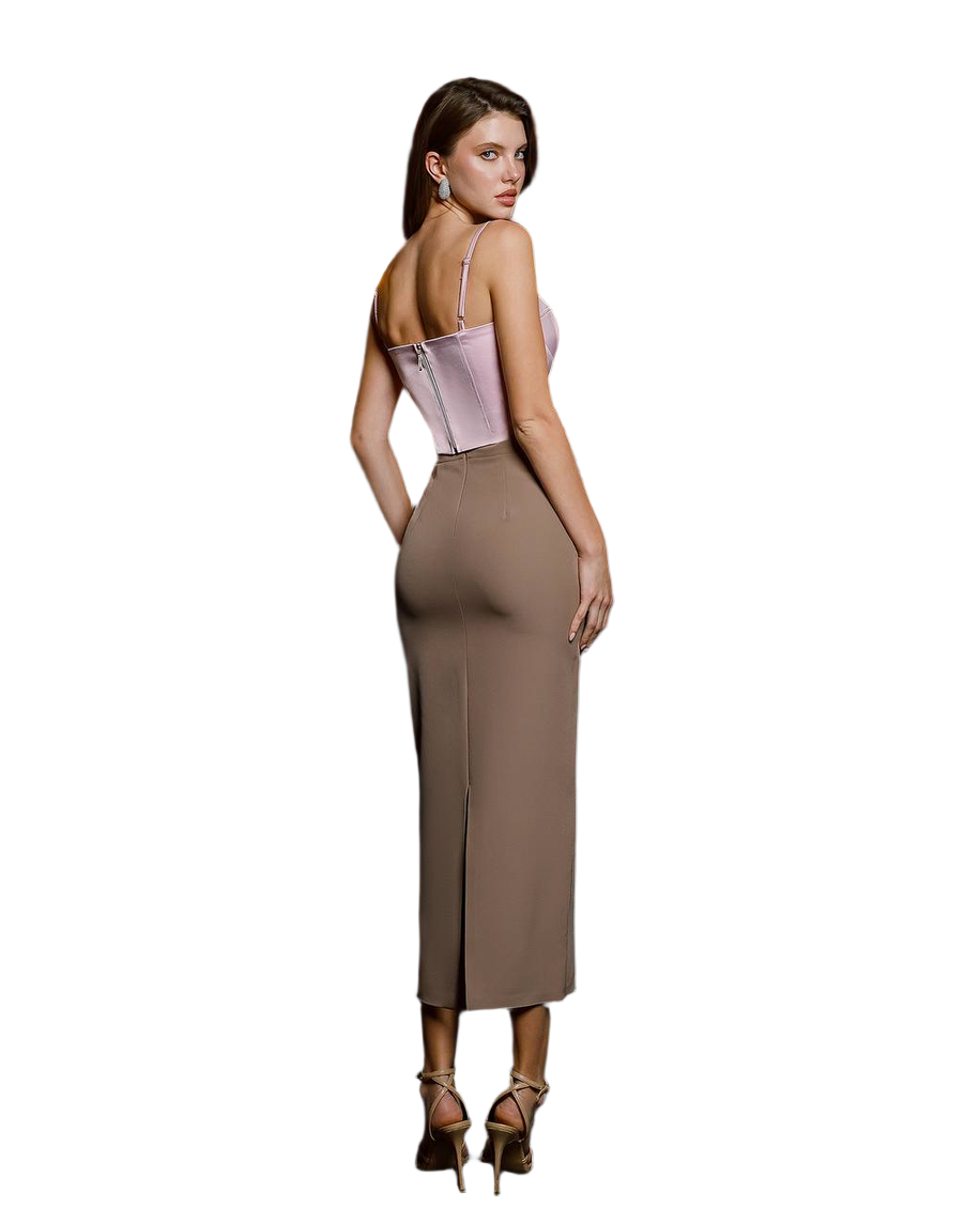 Woman wearing a two-tone dress with a pink top and brown skirt on a white background