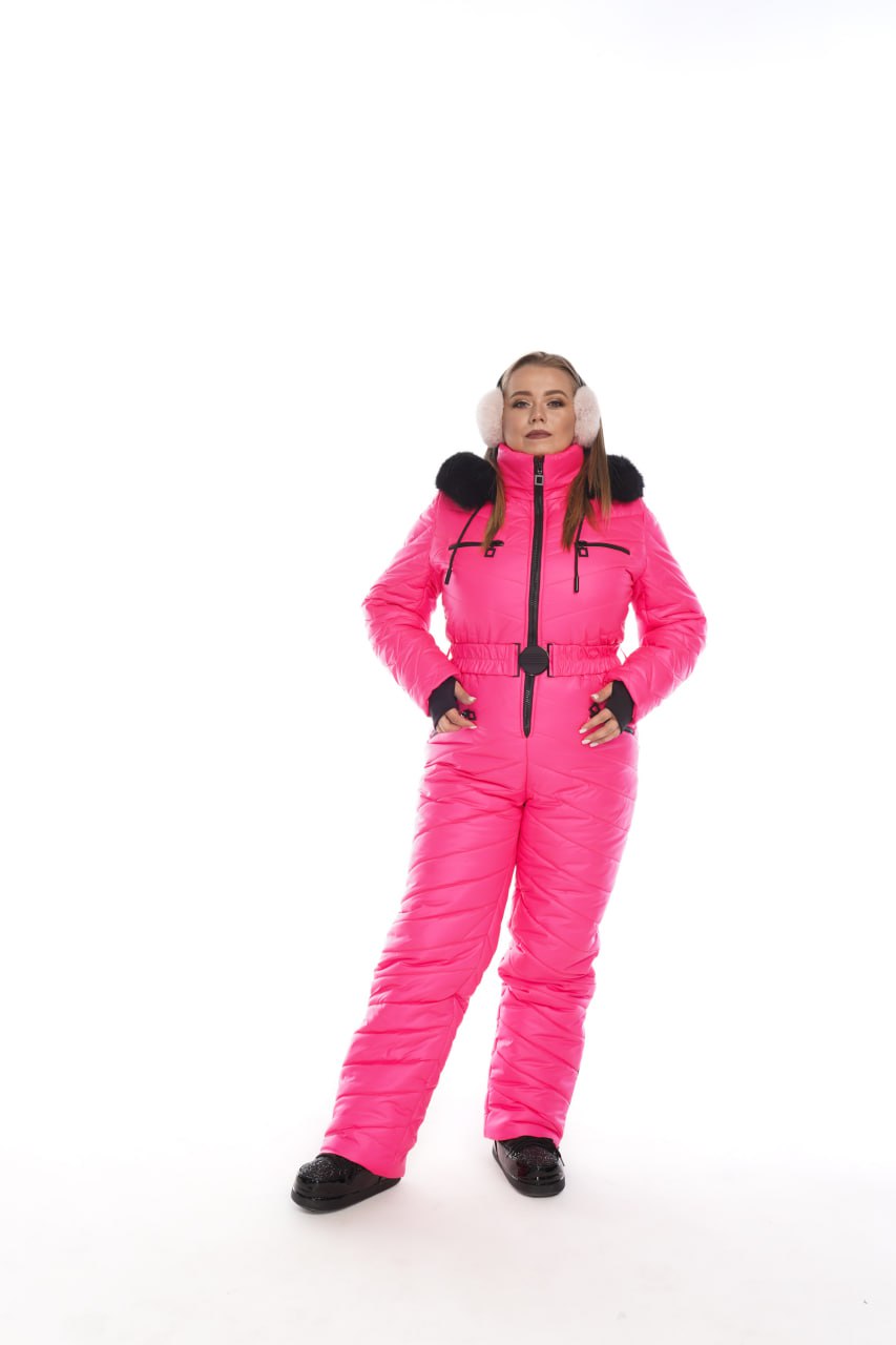 Person wearing a bright pink snowsuit with black accents on a white background