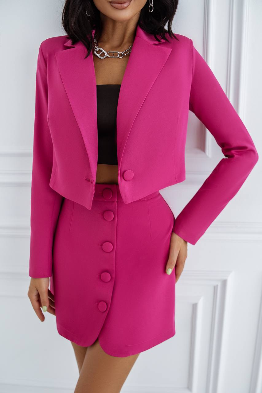 Woman wearing a pink suit with a white background
