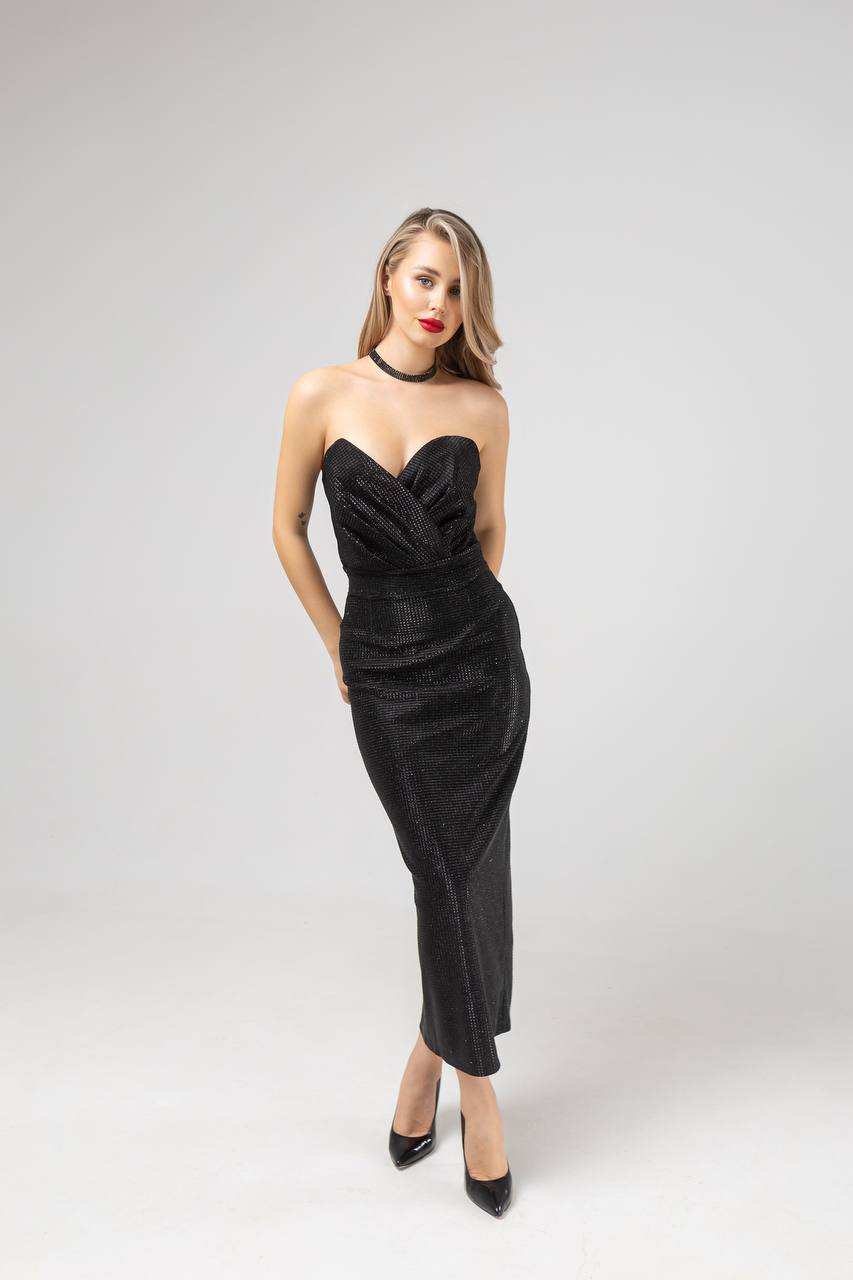 Woman wearing a black strapless dress on a white background