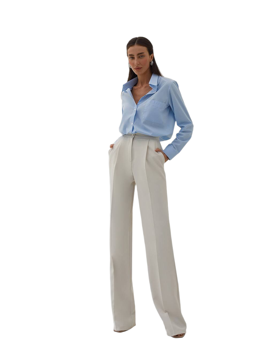 Woman wearing a light blue shirt and beige pants on a white background