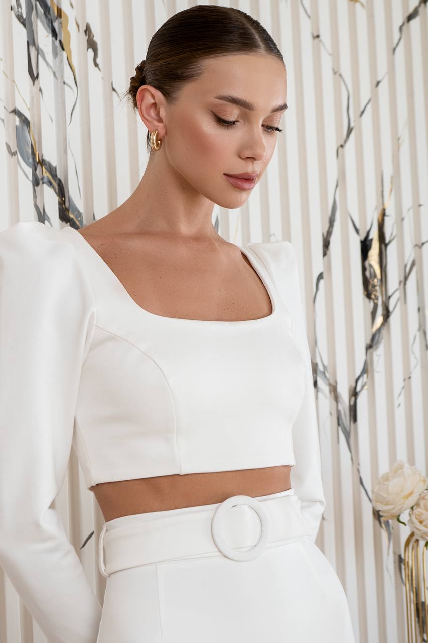 Woman wearing a white outfit with a floral background