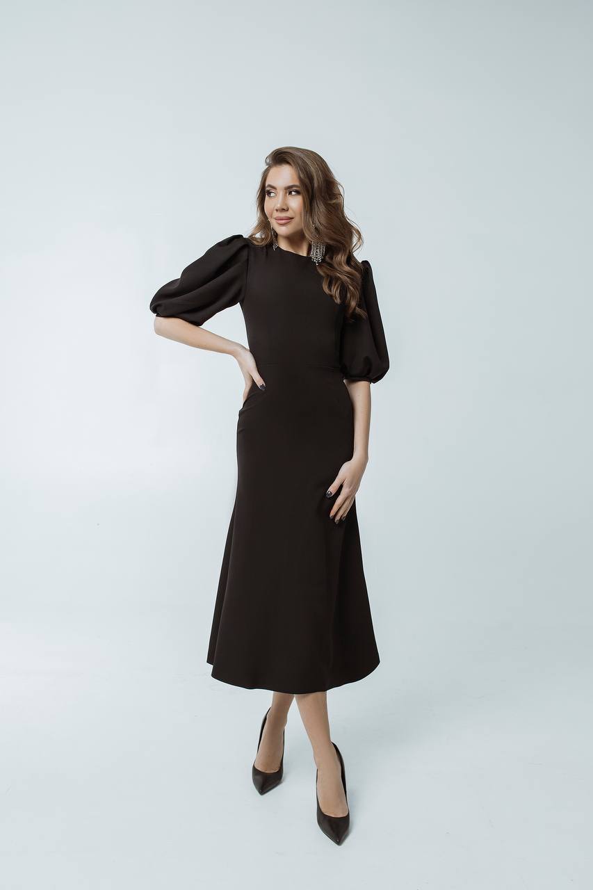Woman wearing a black dress on a white background