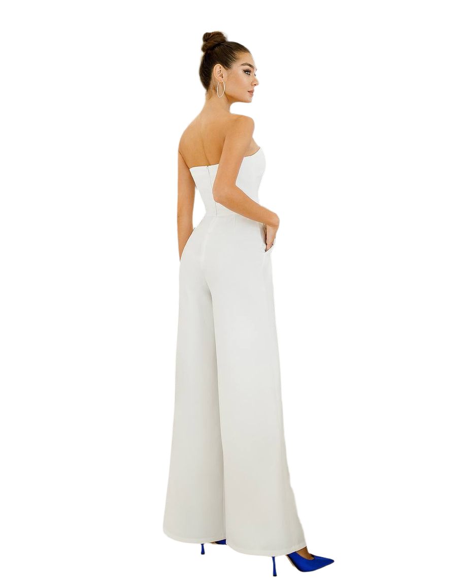 Woman wearing a white strapless jumpsuit on a white background