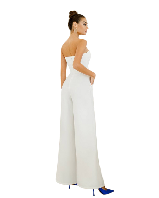Woman wearing a white strapless jumpsuit on a white background