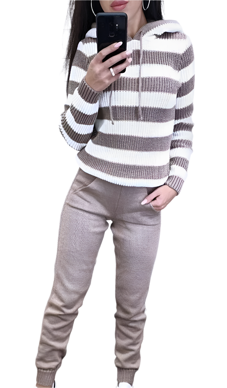 Person wearing a striped sweater and beige pants on a white background
