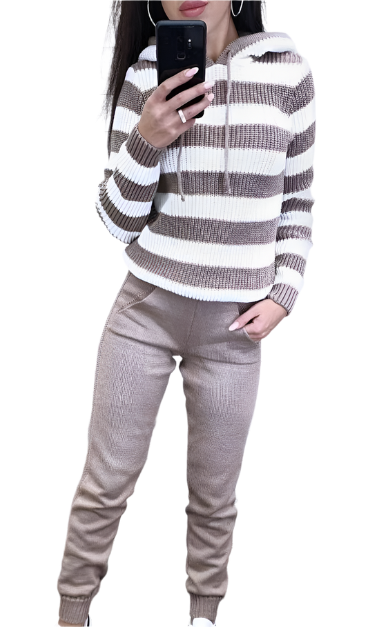 Person wearing a striped sweater and beige pants on a white background