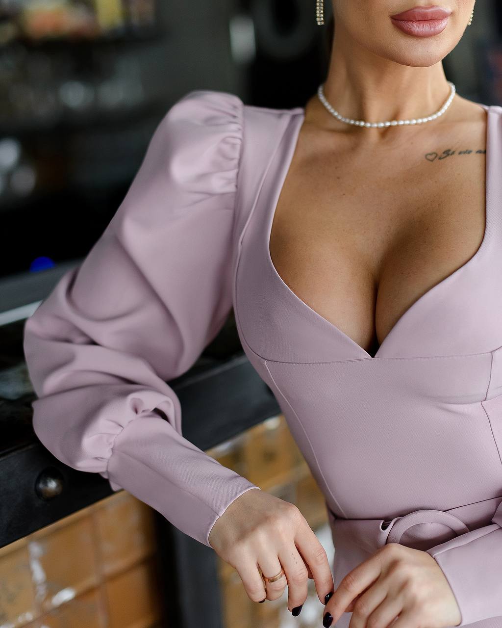 Woman wearing a light purple dress with a blurred background