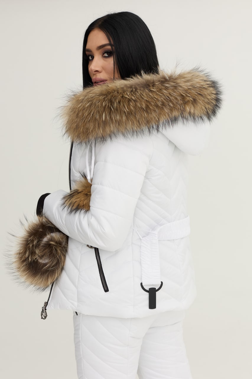 Person wearing a white winter coat with a fur-lined hood on a plain background