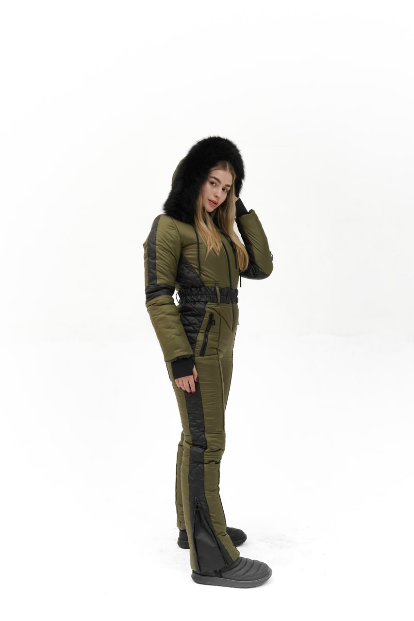 Person wearing a green winter coat with a fur-lined hood on a white background