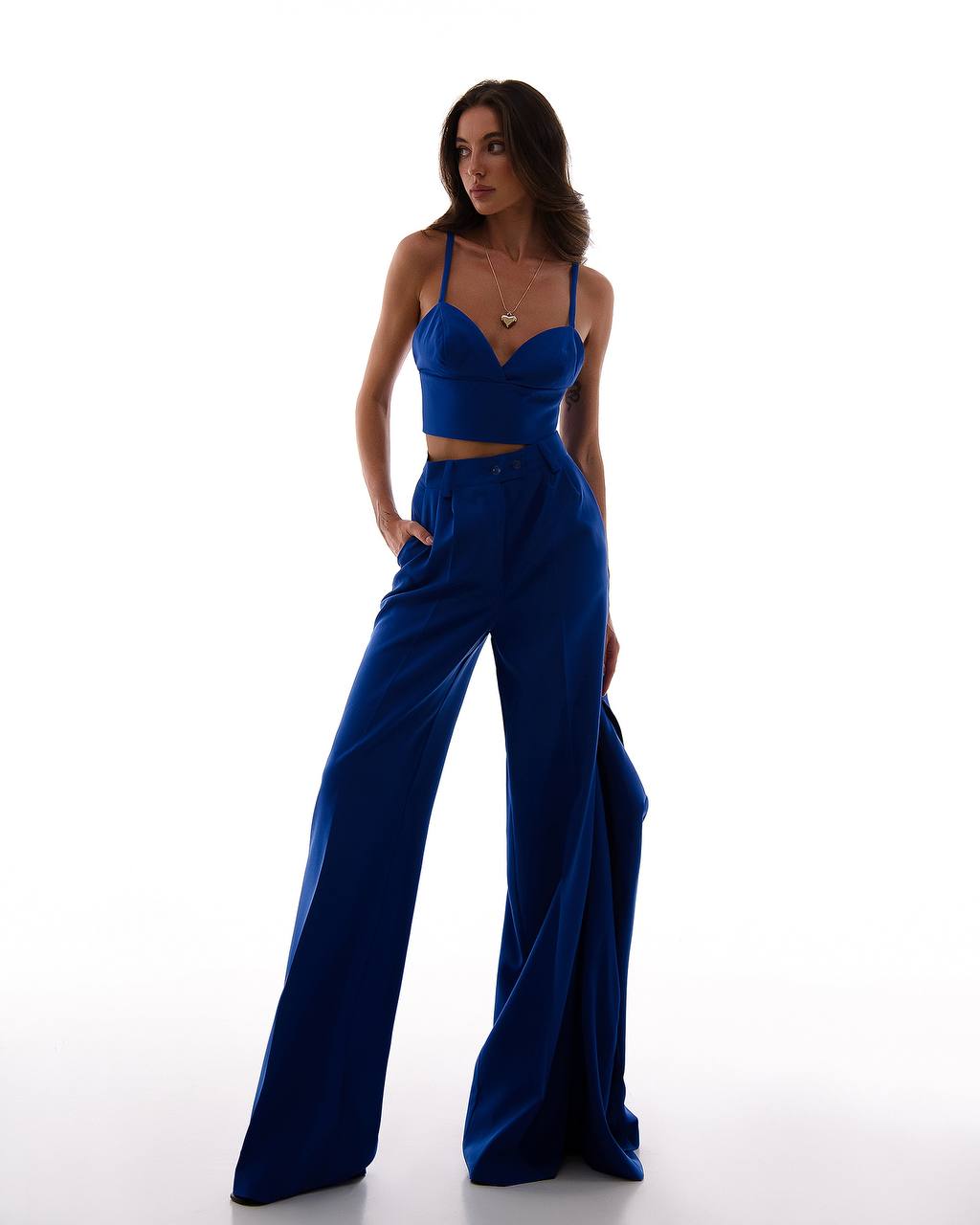 Woman wearing a blue jumpsuit on a white background