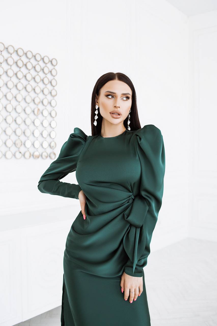 Woman wearing a green dress with a white background