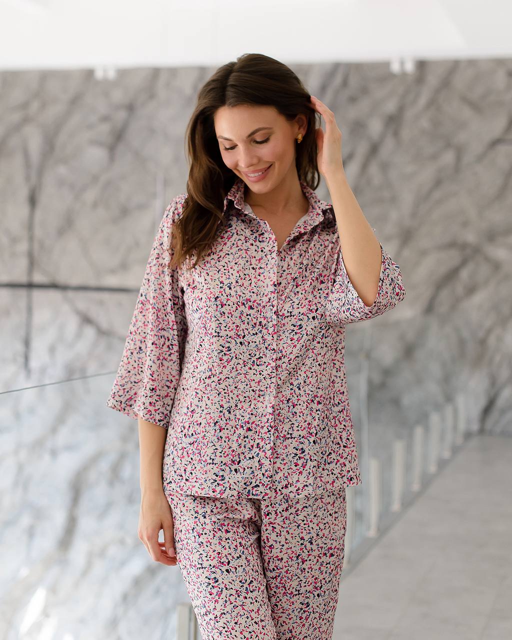 Woman wearing a floral pajama set in a modern indoor setting