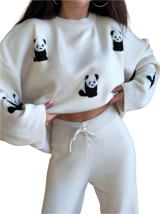 White sweater with panda designs worn by a person on a white background