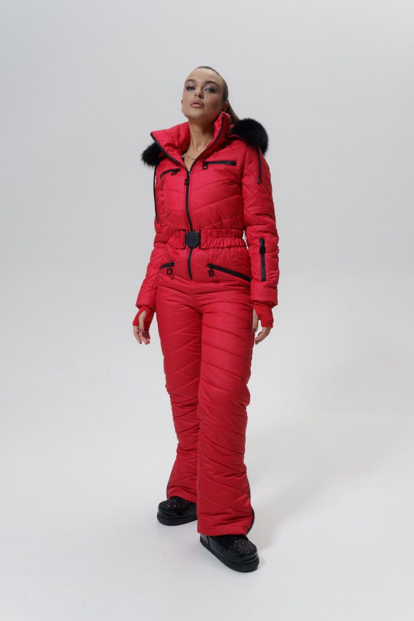 Person wearing a red snowsuit with black boots on a white background