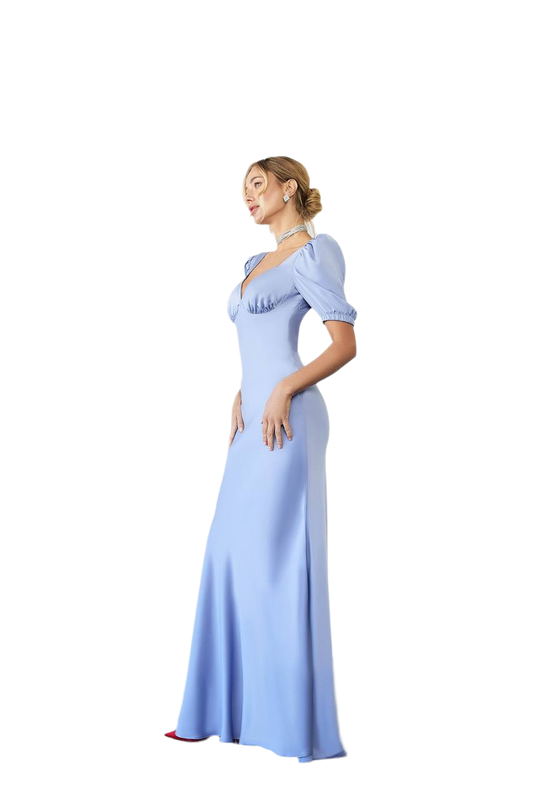 Woman wearing a light blue evening gown on a white background
