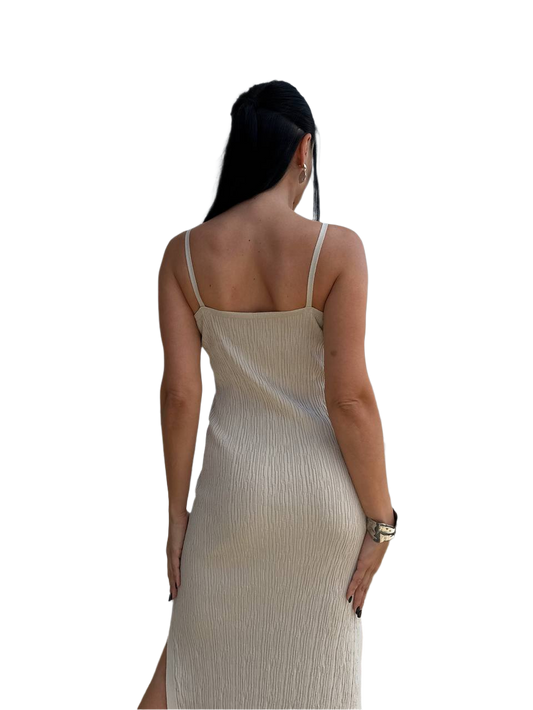 Woman wearing a beige slip dress on a white background